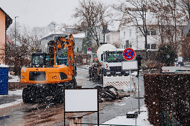 istock Excavator and Cement Truck at Winter Roadwork Site 2250968473