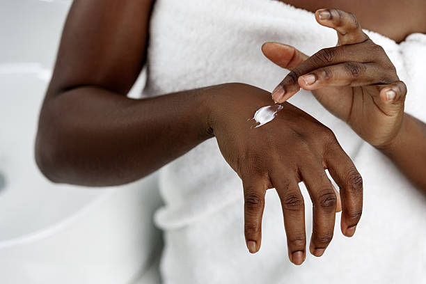 istock Person applying moisturizer to hand in a calm indoor setting during a skincare routine 2250969890
