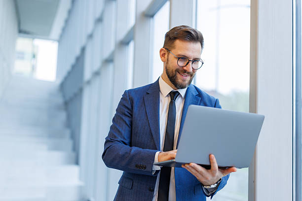 istock Professional businessman using laptop, working in modern office 2250973034
