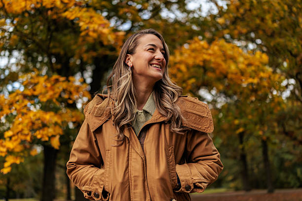 istock Smiling Woman Standing Outdoors in Autumn 2250974081
