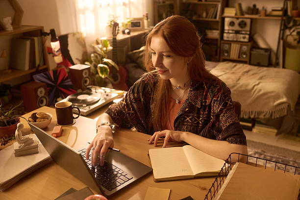 istock Young Woman Working Remotely Using Laptop in Cozy Home Office 2250975848