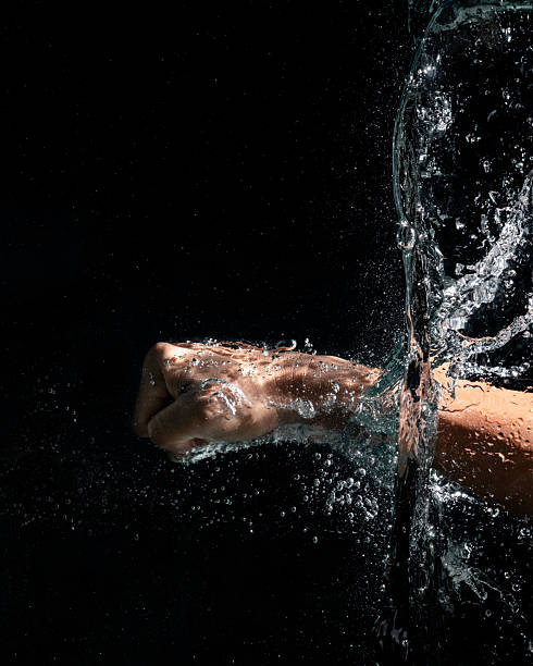 Swimming Watch. Smartwatch for swimming training. Watersport with sports watch. Multi-sport with smartwatch. Watch for Watersports. Waterproof Watch on hand of the swimmer. Swim Smartwatch underwater.
