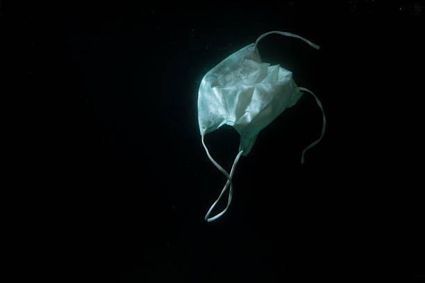 istock Used mask trash that sinks in water 2250977833