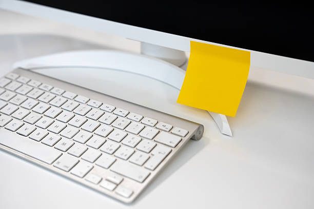 A Clean Slate Unused Blank Yellow Sticky Note Resting on a Bright White Modern Office Desk
