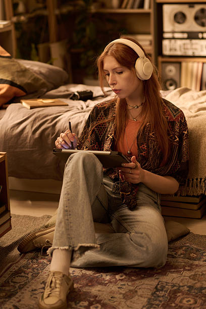 istock Young Woman Sitting on Floor Using Digital Tablet and Stylus 2250980470
