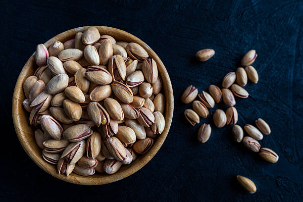 istock Bowl of Roasted Pistachios on Dark Background 2250981034