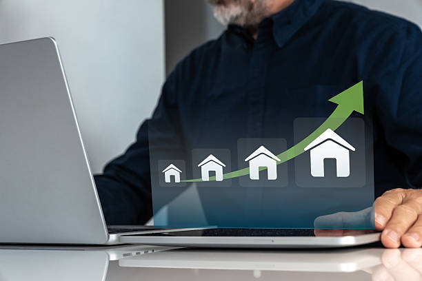 istock Businessman analyzing real estate market growth and urban development on a virtual chart 2250981359