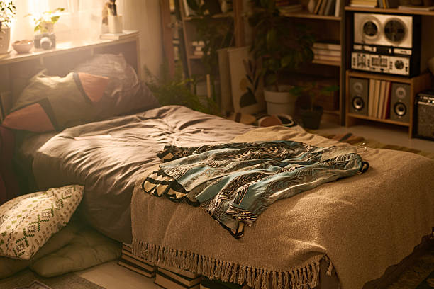 istock Empty Cozy Bedroom Interior Featuring Sunlight Streaming Onto Unmade Bed 2250981541