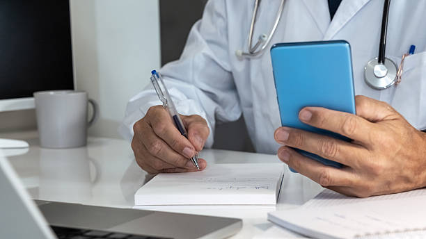 istock Doctor engaging with a smartphone in a modern medical setting, seamlessly integrating digital tools into patient care 2250982007