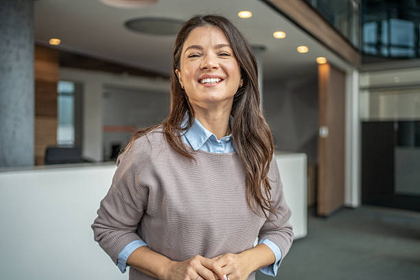 istock Smiling businesswoman standing in modern office environment 2250982552