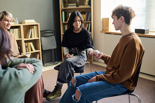 istock Diverse Teenagers Sharing Object and Building Trust during Group Therapy Session 2250983817
