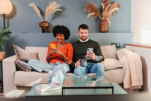 istock Happy couple enjoying quality time together while using their smartphones and sharing their experiences 2250987648