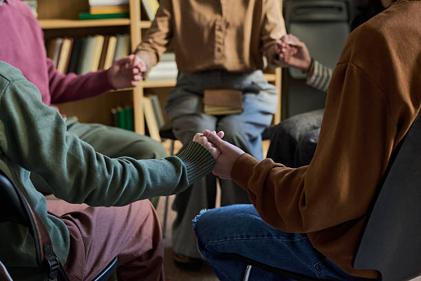 istock Diverse Young People Sitting in Circle Holding Hands during Group Therapy 2250987655