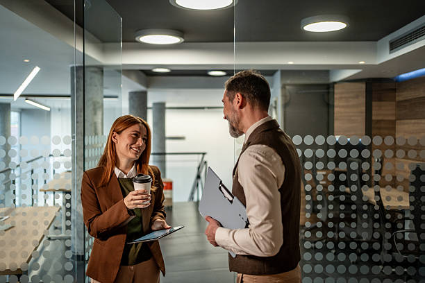istock Business colleagues talking during coffee break in modern office 2250989903