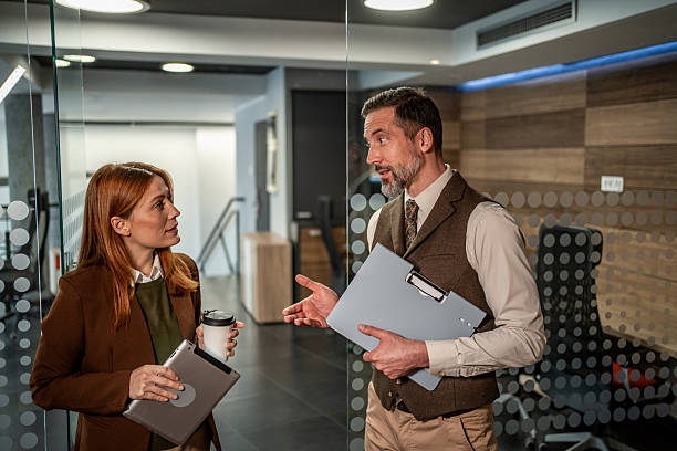 istock Business colleagues having spontaneous discussion in modern office 2250989914