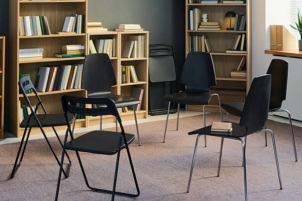 istock Chairs Forming Circle in Library Setting Preparing for Group Therapy Meeting 2250995144