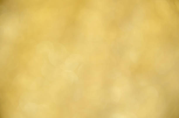 Yellow glow. Abstract background. Light and bokeh. A bright holiday template. Golden background for congratulations. A screen saver with a Bokeh.