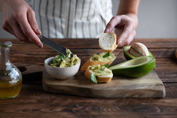istock Spreading fresh avocado on bread, healthy kitchen cooking close-up 2251006340