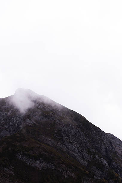 istock Weathered Mountain Tops Wrapped In Dense Fog Create Atmospheric And Dramatic Scenery For Photography 2251008125