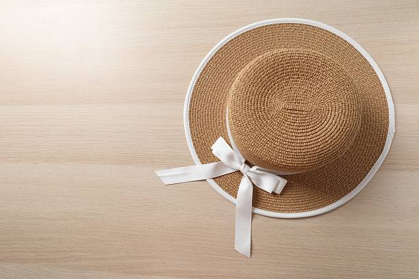 istock Straw hat on wooden background 2251008612
