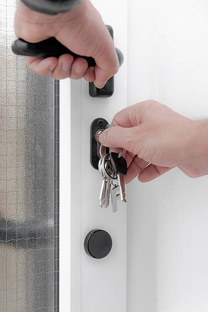 istock Person unlocking a door with key. 2251008629