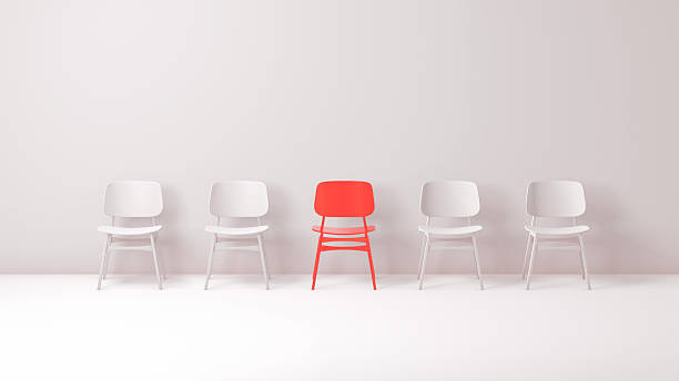 istock Red Chair Standing Out Among White Chairs – Minimalist Concept 2251008910