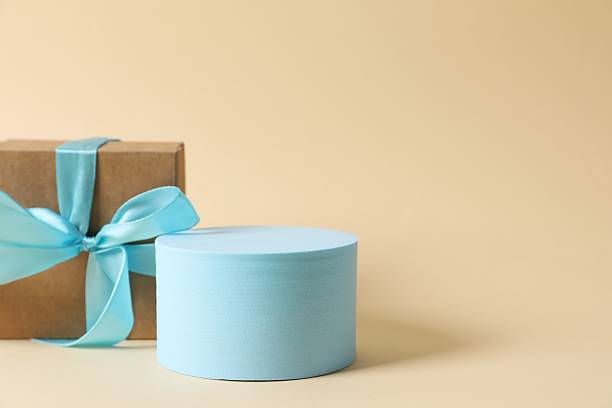 Blue podium with gift box on color background
