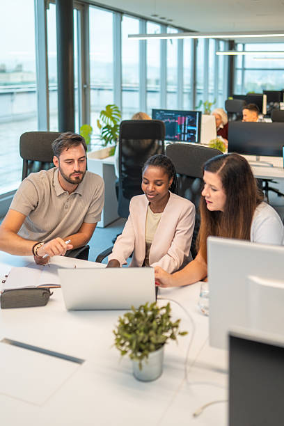 istock Diverse Team Collaborating Around Laptop in Bright Office 2251015264