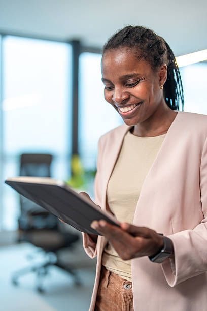 istock Smiling Mid Adult Black Professional Utilizing Tablet in Bright Workspace 2251015291