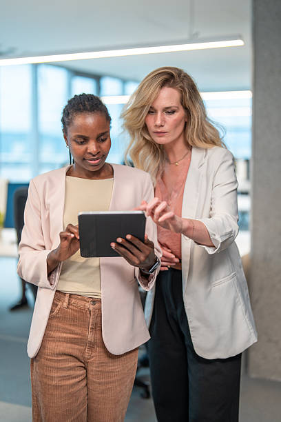 istock Two Engaged Businesswomen Collaborating on Digital Tablet in Office 2251015293