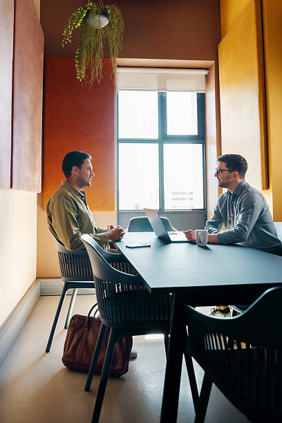 istock Two professionals engaged in a discussion in a modern office setting 2251015646