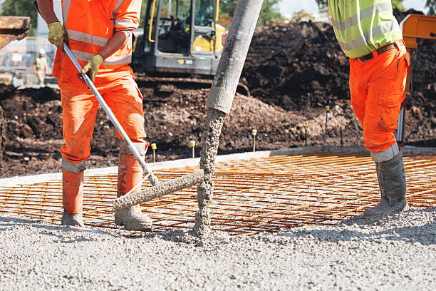 istock Concrete pouring process at a construction site with builders and concrete pump 2251017010