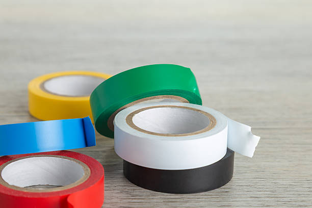 istock Six rolls of colored tape on light wooden surface. 2251017379