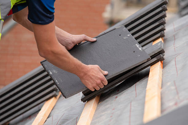 istock Skilled worker busy applying roofing material on sloped roof focused on securing elements for sturdy structure in bright daylight 2251017489