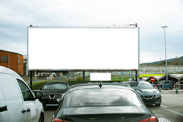 A large blank billboard in a parking lot