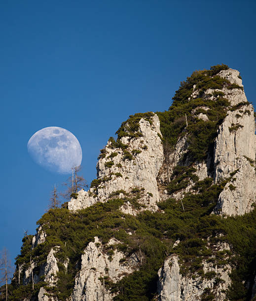istock Moon rising behind Mountaintop 2251022557