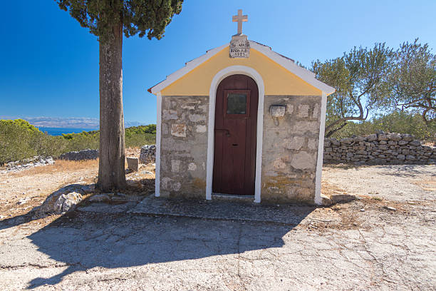 istock Charming Small Chapel and Tall Cypress Tree Overlooking a Scenic Mediterranean Landscape, Donja Krusica, Solta, Croatia 2251023052
