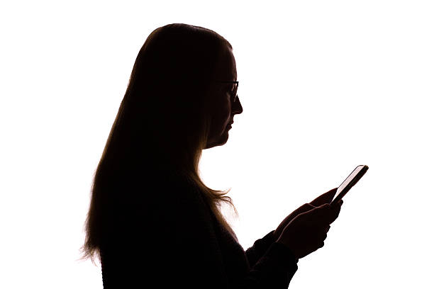 istock Silhouette of young woman using smartphone on white background 2251023309