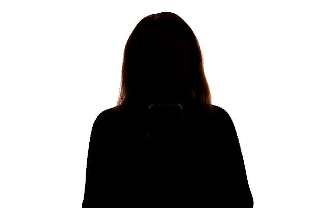 istock Silhouette of young woman using smartphone on white background 2251023375