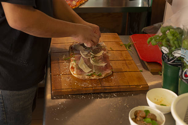 istock Chef expertly assembling sandwich with herbs and seasonings in cafe kitchen 2251026273