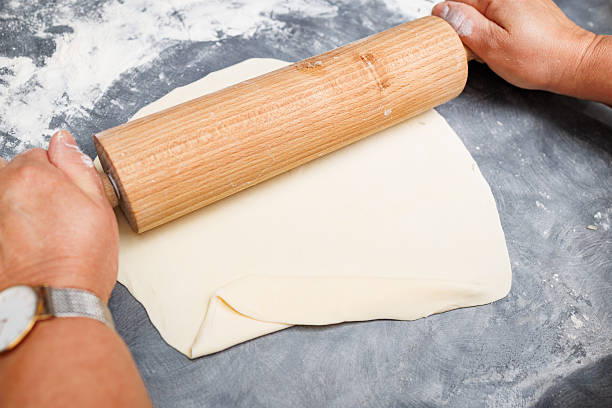 istock Hands Rolling Dough with Wooden Rolling Pin 2251026395