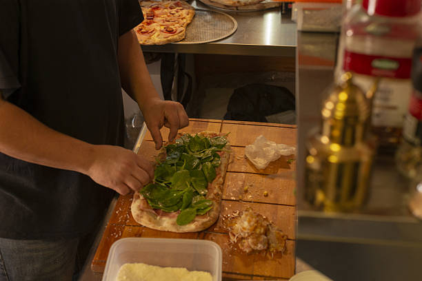 istock Artfully placing vivid arugula atop smooth melted cheese for display 2251030626