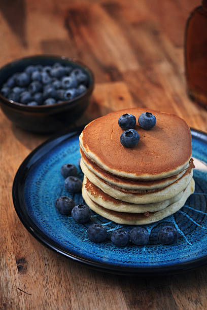Stack of Pancakes with Butter, Blueberries and Maple Syrup
