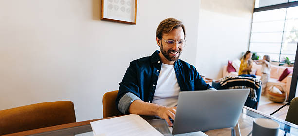 istock Man working from home with family in background 2251031263