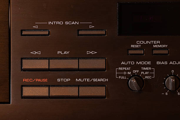 This close-up image features the controls of vintage audio equipment. The array of knobs and buttons, along with the headphone jack, highlights the technical diversity and precision of early Hi-Fi technologyThis close-up image features a stack of vintage audio amplifiers and CD players. The detailed controls and robust construction are characteristic of high-quality Hi-Fi equipment from past decades. Perfect for retro tech enthusiasts, music lovers, and collectors of vintage audio gear