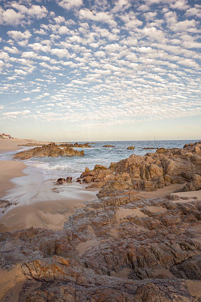 istock A rocky beach with a cloudy sky in the background 2251032935