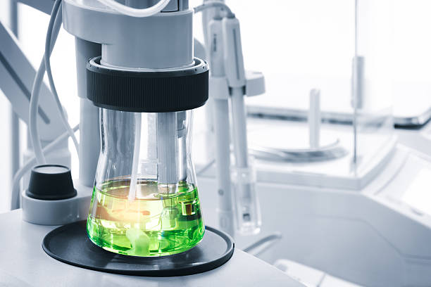 istock green liquid is in a glass beaker on a black surface. beaker is on a table next to a white table, chemical pharmaceutical production concept 2251033810