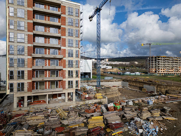 istock Construction site of a multi-story residential building covered in scaffolding, workers finishing exterior walls, captured in a detailed urban development scene 2251034430