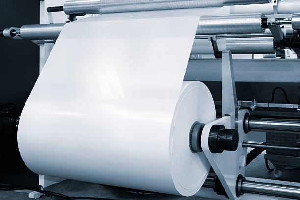 istock Automatic polyethylene plastic bag production machine with lighting effect. Close-up of the roller of the plastic bag production machine in the light blue scene. product packaging concept 2251036125