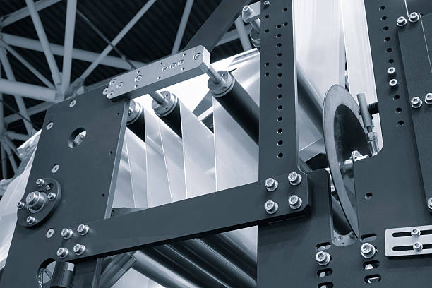 istock Automatic polyethylene plastic bag production machine with lighting effect. Close-up of the roller of the plastic bag production machine in the light blue scene. product packaging concept 2251036333